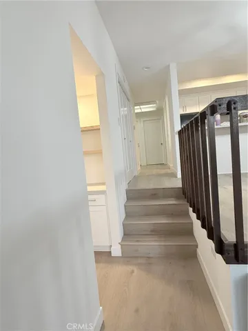Base of stairs from living room towards main front door entry.