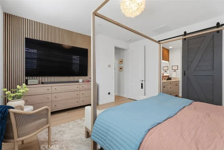 Wake up in a spacious primary retreat featuring a custom barn door, thoughtfully designed finishes, and a peaceful atmosphere perfect for unwinding at the end of the day.