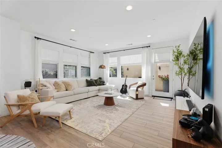 Filled with natural light from windows on three sides, the spacious great room offers a bright, airy atmosphere and effortless flow to the backyard.
