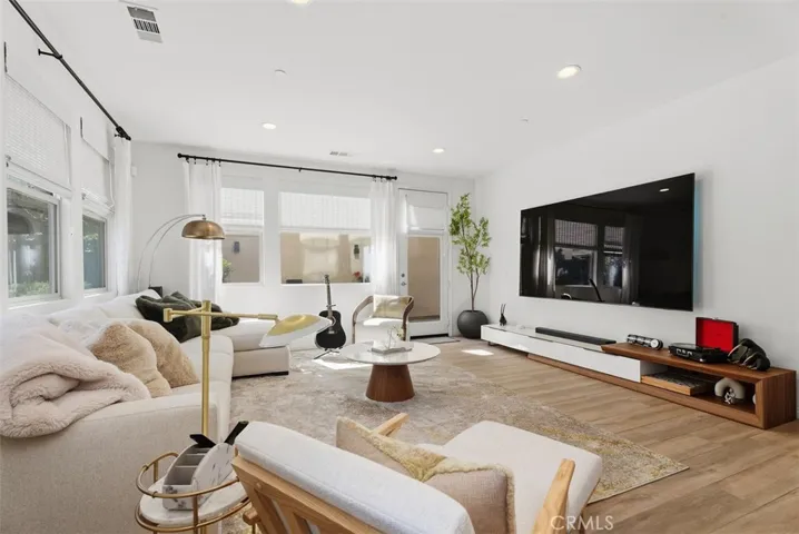 Large windows with custom window coverings enhance the space while filling the great room with beautiful natural light.