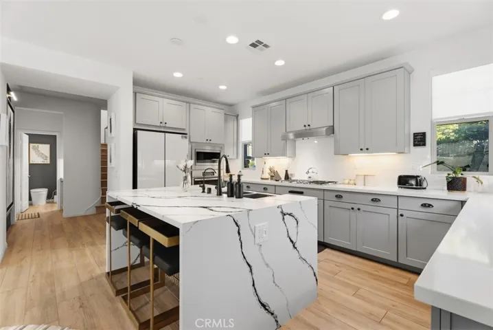 Open to the dining area and great room, the kitchen was designed for effortless entertaining, with the dramatic marble island serving as the home's natural gathering place.