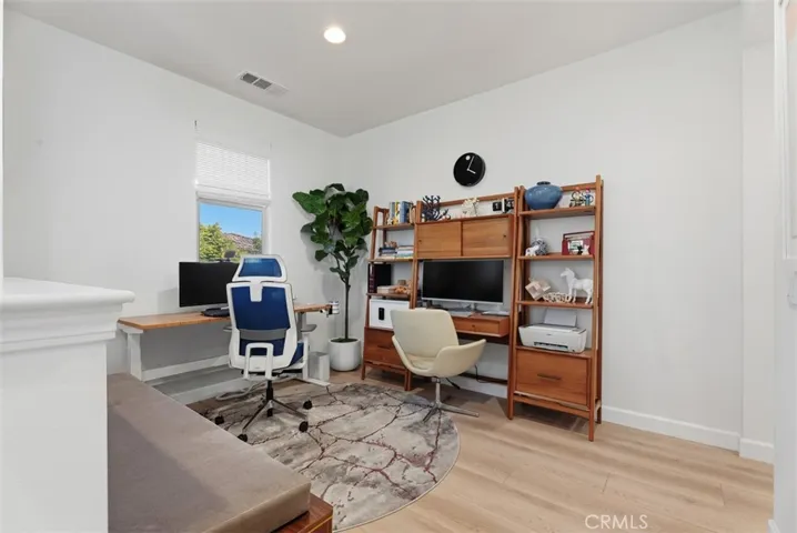 The spacious upstairs loft offers flexible living space ideal for a home office, media room, playroom, fitness area, or second family room.