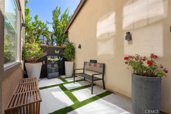 The fenced courtyard extends your living space outdoors with room for conversation, container gardens, or al fresco dining.