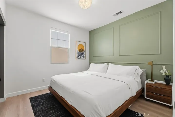 This spacious secondary bedroom offers flexibility for work, study, or relaxation with space for a desk or seating area, plus a walk-in closet featuring custom organization.