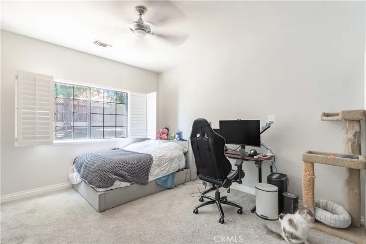 Another bedroom with a large window and shutter