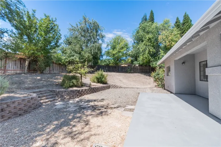 Outside is a spacious  yard ready for your needs and ideas