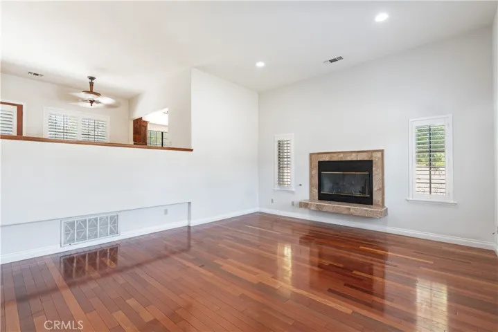 This large living room is open to the dining area and kitchen above and includes a gas fireplace.  Windows are everywhere and bring in lots of light!