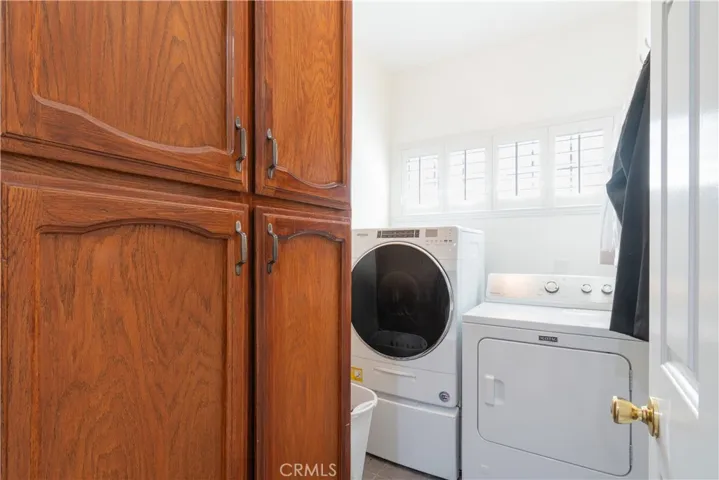 Utility room with a large storage cabinet.  Washer and dryer can stay if needed