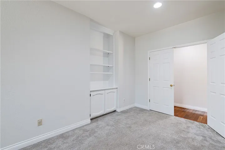 Another view of the some of the cabinetry in this bedroom which has a double door entry