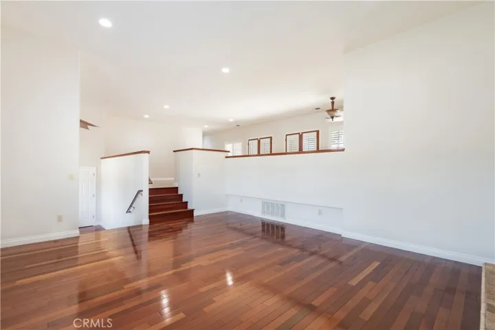 The living room leads to an upper level of more living and dining space