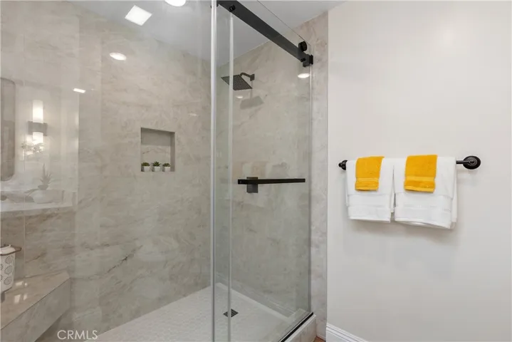 Main bathroom with walk-in shower and glass & chrome barn door style enslosure