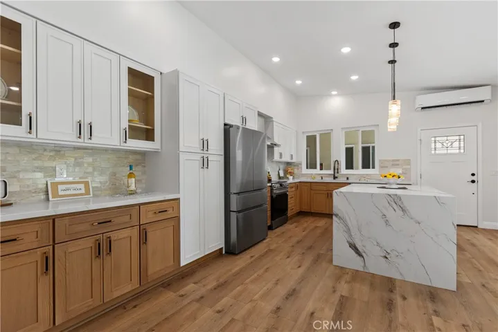 Remodeled kitchen with huge quartz covered island