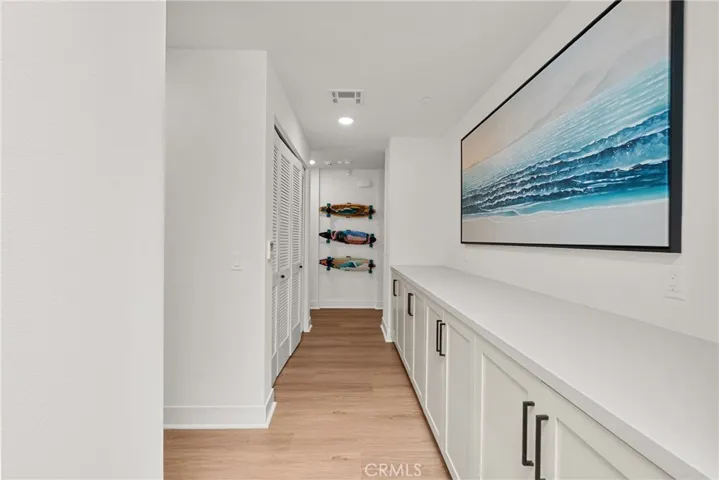 Hallway with linen cabinets and storage