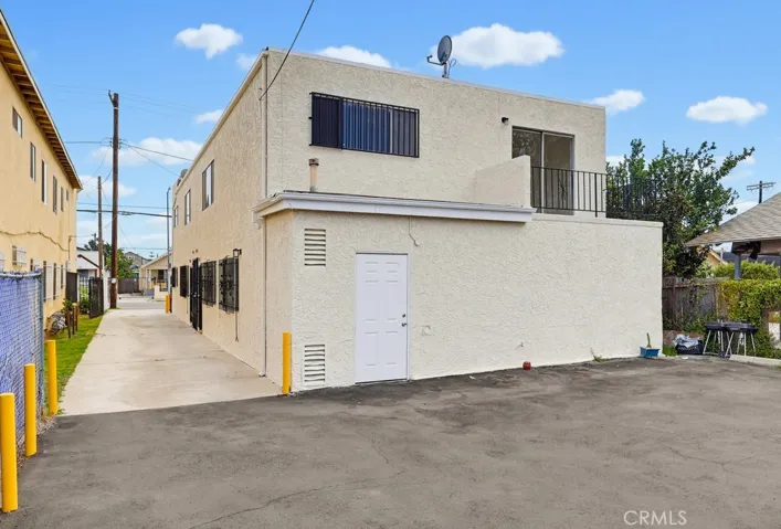 Rear of Building.  Door accesses storage room with water heater.