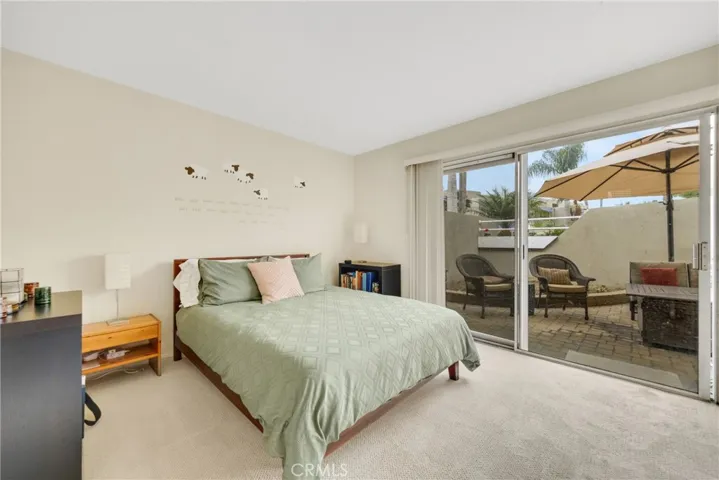 Guest bedroom with a view to the patio.