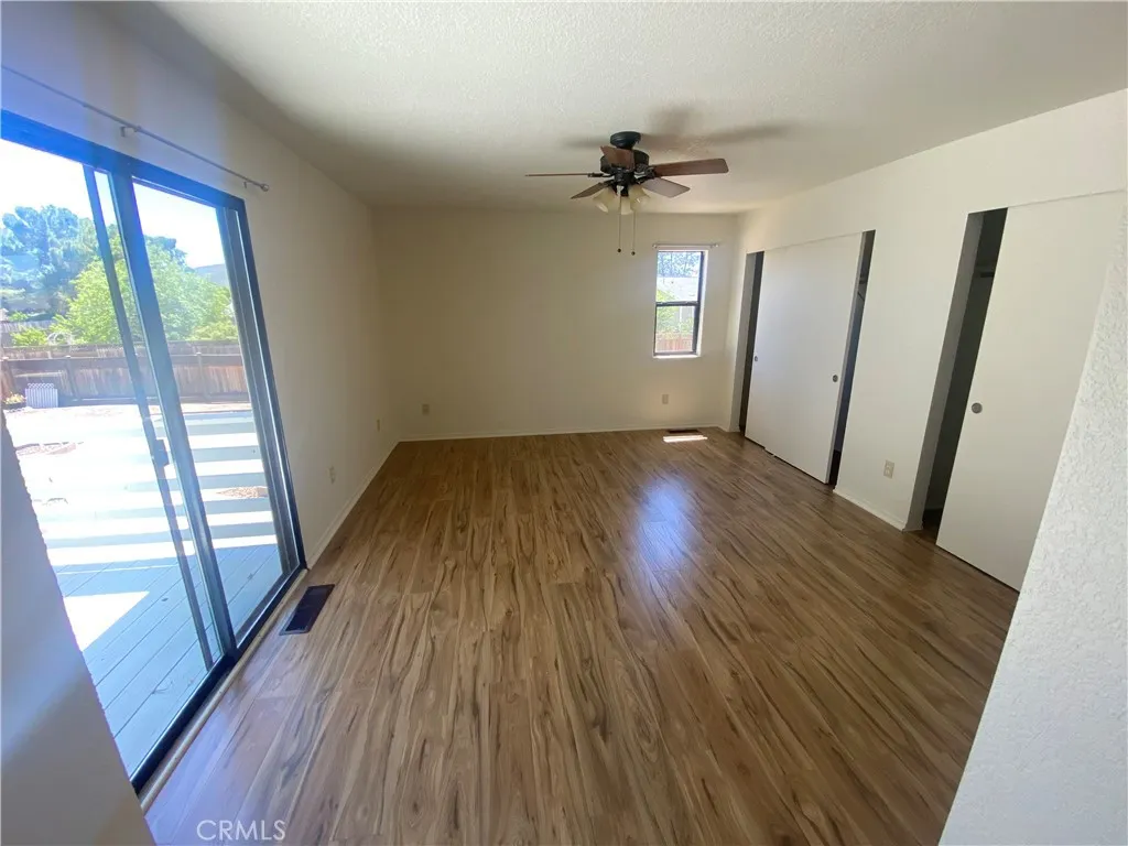 Primary bedroom has slider to back deck.