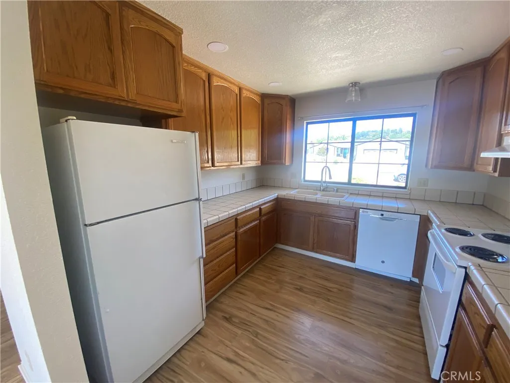 Kitchen has large window to front yard.