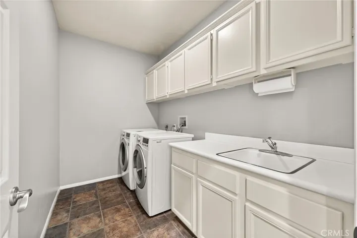 Laundry room with extra storage and sink