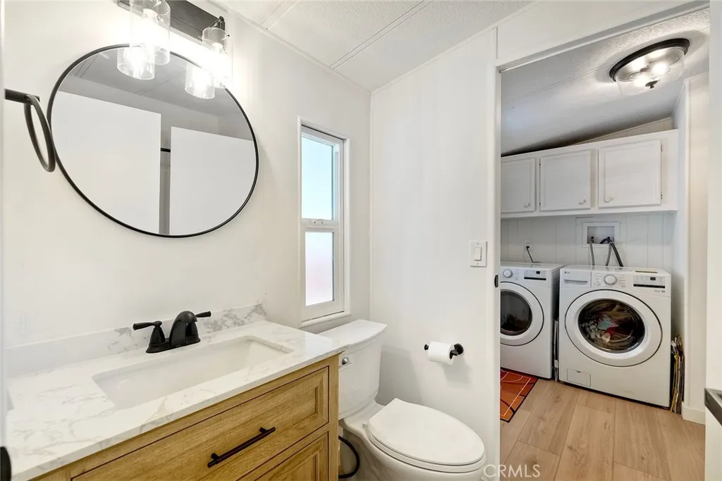 GUEST BATHROOM OPENS TO LAUNDRY ROOM.