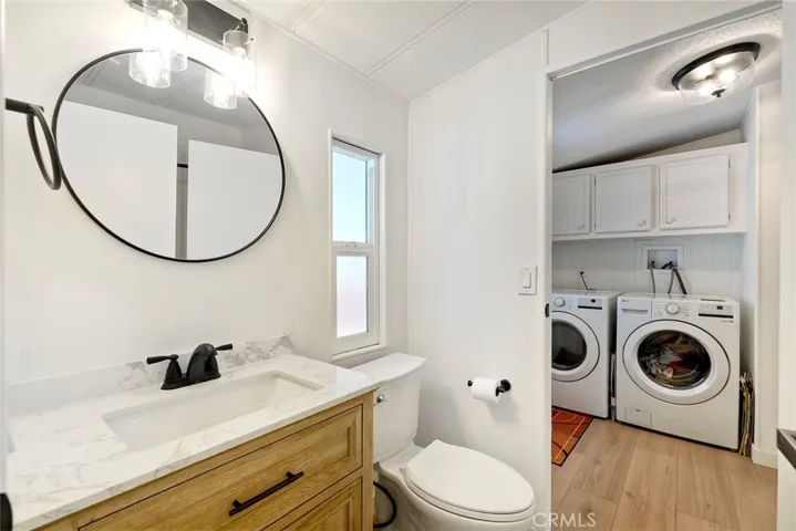 GUEST BATHROOM OPENS TO LAUNDRY ROOM.
