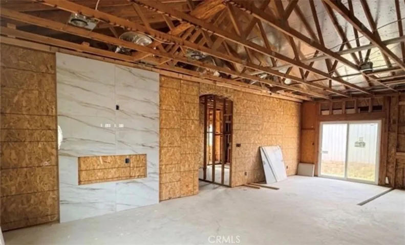 Open Living Room & Dining Area Featuring Fireplace