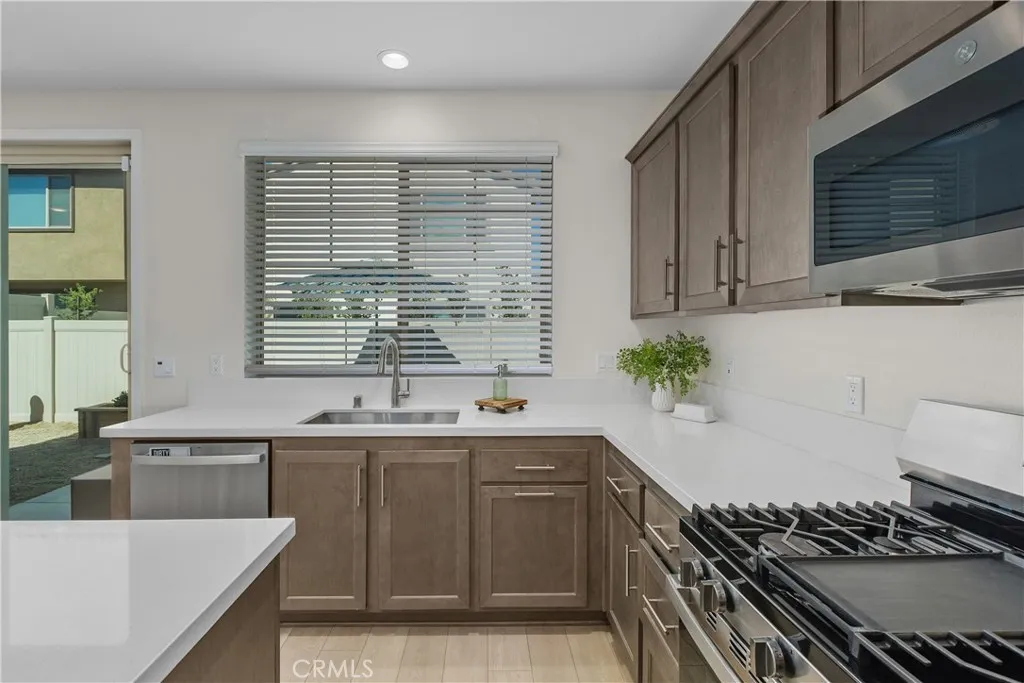 Extra large SS sink with large window providing plenty of natural light.