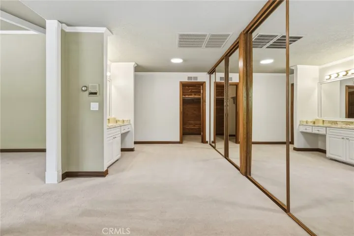 Dressing area with wall of closets + walk in cedar closet