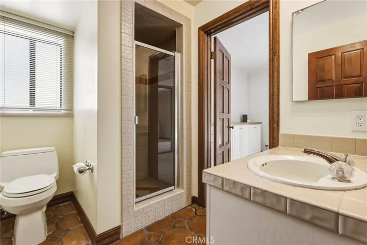 Bathroom off of kitchen that adjoins first bedroom