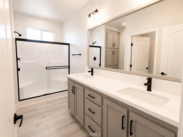 Primary bathroom, duel sinks and storage area