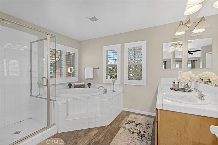Primary bathroom with separate tub & shower & dual sinks.  Walk-in closet to the right.