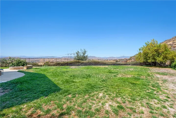This expansive lot on the right side of the residence offers significant potential for creative development.