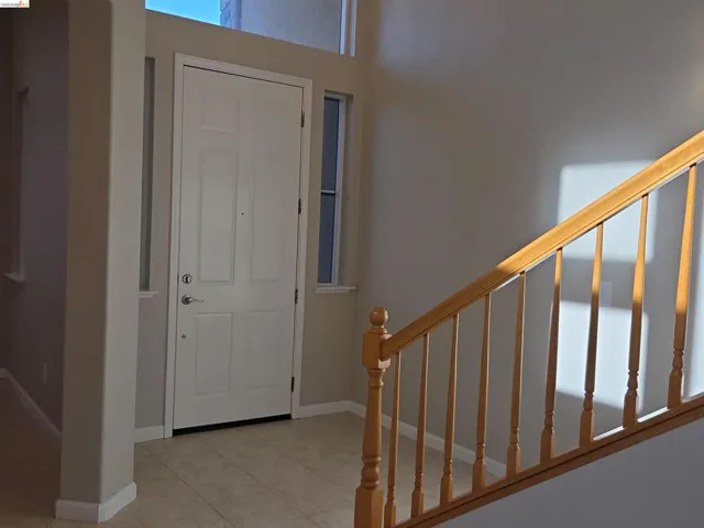 Entryway featuring a paneled door with sidelights and transom window