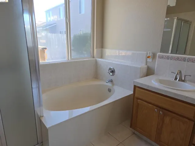 Integrated bathtub with surrounding tile deck and window