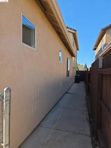 Exterior stucco siding with multiple windows