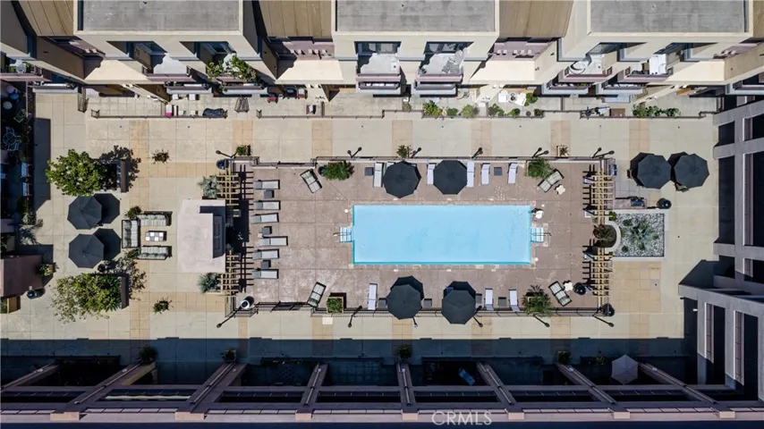 Overhead aerial view of the pool courtyard and surrounding community amenities.