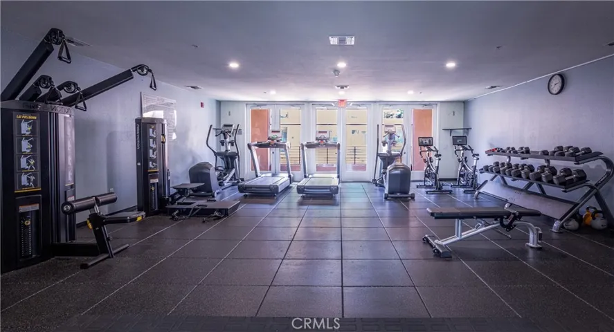 Well equipped community fitness center with cardio machines, weights, and strength training equipment.
