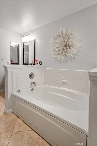 Oversized soaking tub creates a relaxing retreat within the primary bathroom.