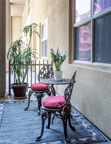 Courtyard-side patio offers an additional outdoor seating area outside the residence.