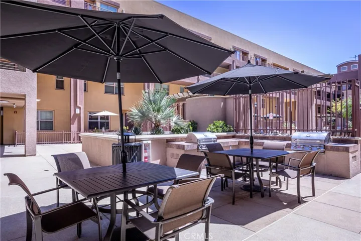 Community BBQ area with shaded dining tables for convenient outdoor entertaining.