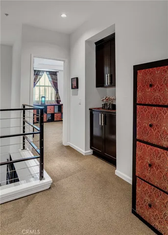 Upper hallway with built-in cabinetry providing convenient additional storage.