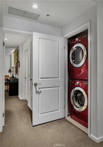 Convenient upstairs laundry closet with space for a full-size stacked washer and dryer.
