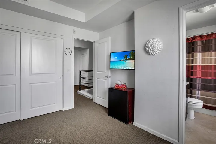 Secondary bedroom with ample closet space and convenient access to the adjacent full bathroom.