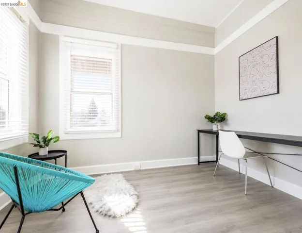 Light wood-finish flooring complements the neutral wall paint in this room