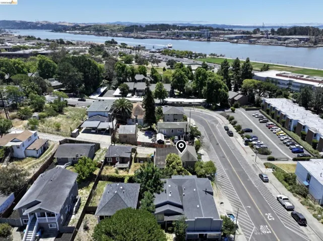 Aerial perspective showcasing a residential property with a partial water backdrop