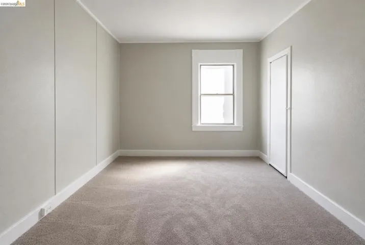 Neutral-toned walls complement the light-colored carpeting