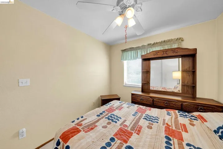 Room featuring a ceiling fan with integrated lighting, a window, and light-toned walls