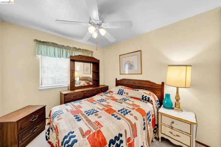 Bedroom featuring soft yellow walls and neutral carpeting