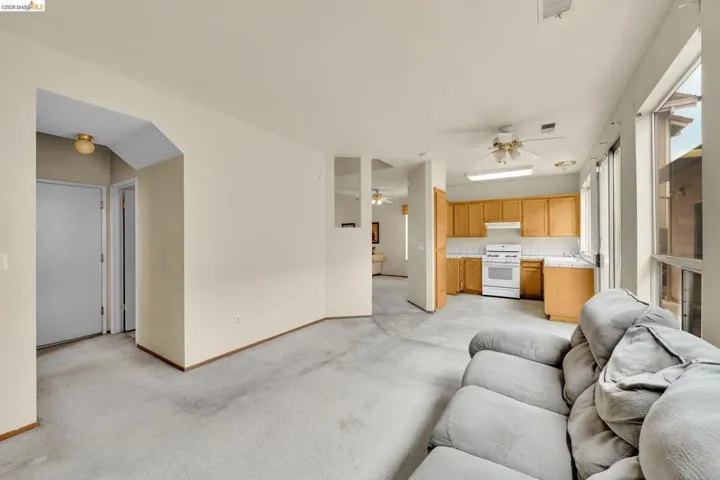 Carpeted living area featuring light-toned walls