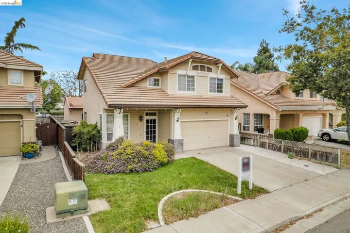 Two-story stucco exterior with a tile roof and attached two-car garage