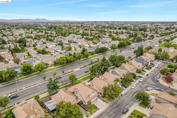 Aerial perspective showcasing residential properties with varied rooflines and mature landscaping